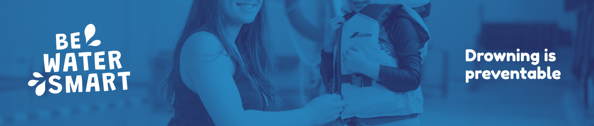 A blue-toned promotional banner showing an adult fastening a life jacket on a child. On the left, the text reads “Be Water Smart” with water droplet graphics. On the right, the message “Drowning is preventable” is displayed.